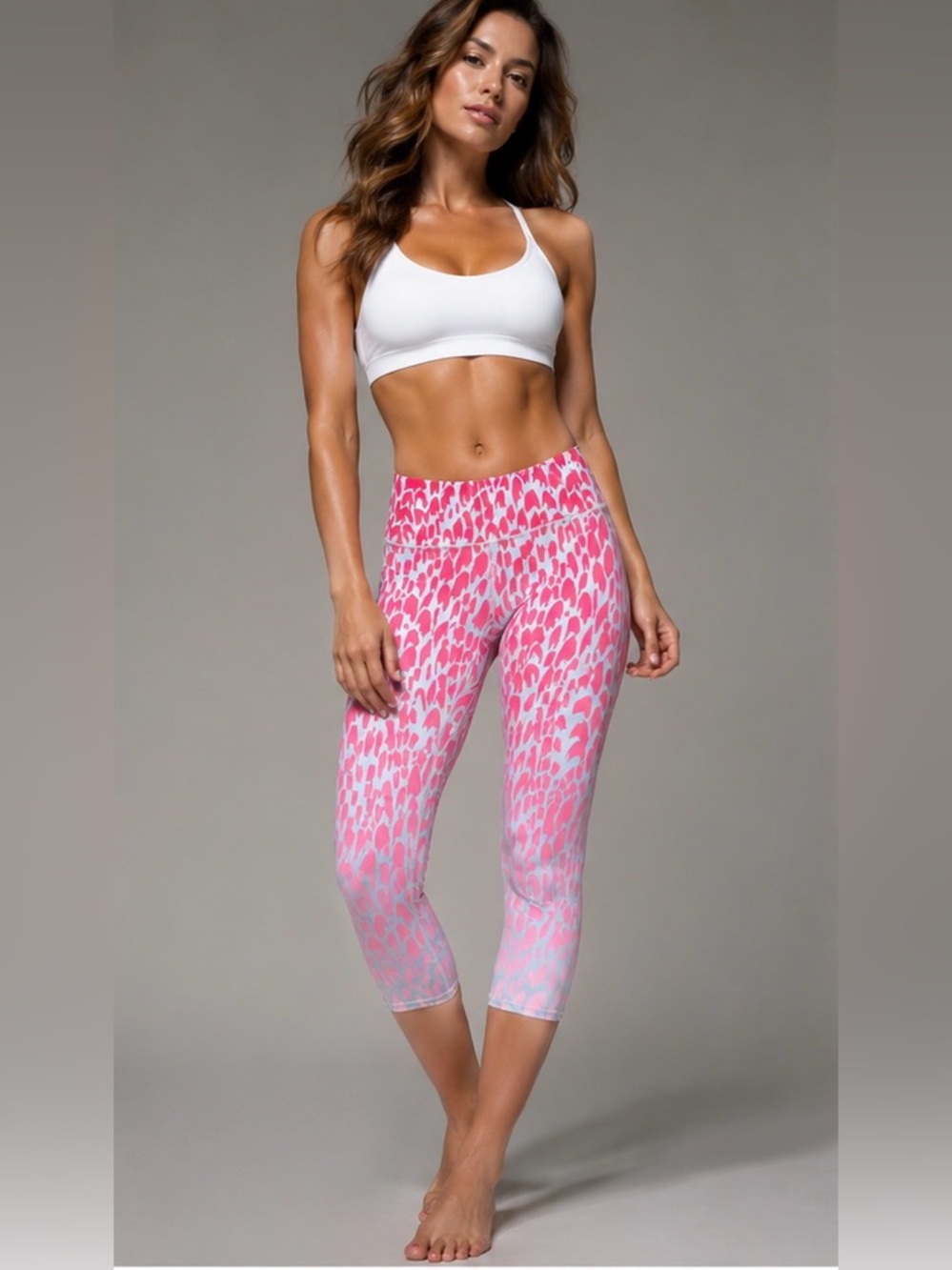 ALO Yoga capri leggings feature a pink and white/gray ombre animal print
